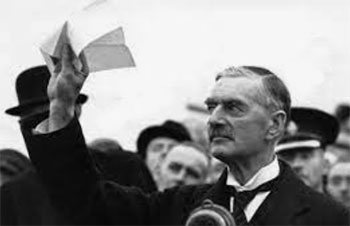 Prime Minister Neville Chamberlain waving document signed by Hitler