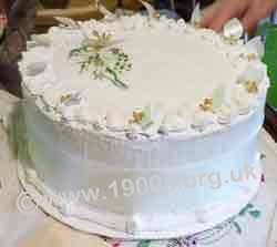 Underside of ardboard cover decorated to look like a luxury wedding cake during 