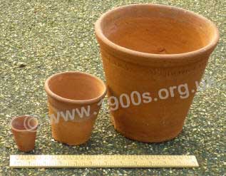 Three clay pots of increasing size from the 1940s. 
The smallest, known as a 'thumbs' was for very young seedlings