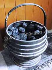 Coal scuttle for storing coal beside a fireplace, commonly used with a coal fire.