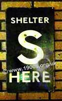 Shelter here sign: enamel placard denoting a WW2 public air raid shelter: white S on a black background