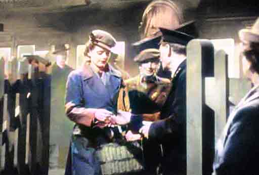 1940s ticket collector checking and collecting passengers' train tickets at the end of a journey to a small rural station