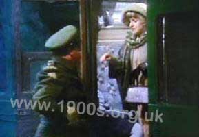 Inside a compartment of an old overland British train, showing the stiff door latch. Screen shot from old film.