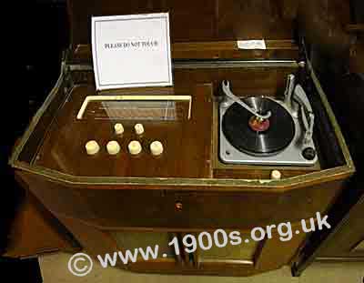 Radiogram, mid-1900ss, with lid open to show the radio and the gramophone.