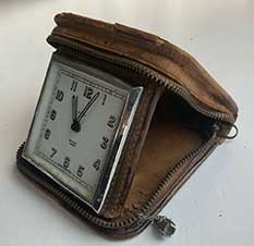Zip shut leather travelling alarm clock, 1950s