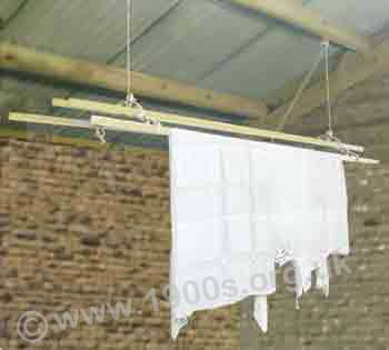 Old wooden clothes airer and dryer which could be hoisted up in a room so that the wet washing was out of the way.
