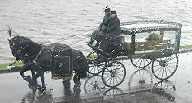 Victorian or Edwardian hearse, transporting a coffin on its final journey