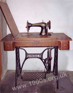 an old treadle type of sewing machine, typical of the late 1800s and early 1900s.