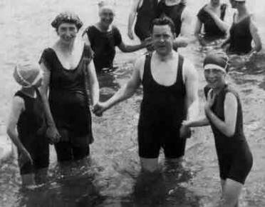 People dressed for swimming, c1915, showing the swimming costumes of a man, a woman and two young girls, thumbnail