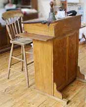 Teacher's high desk and high chair as used in schools in Victorian times, the early 1900s and into the 1940s or later.