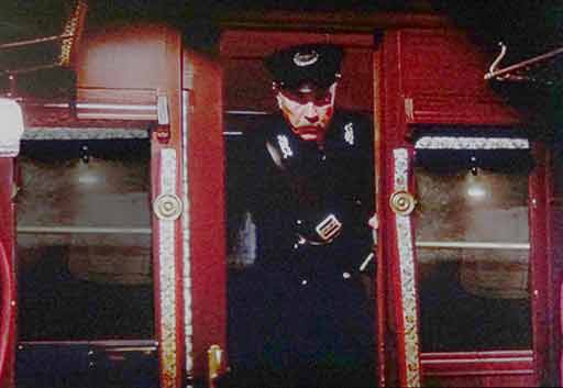 ticket inspector inspecting tickets on an early first-class train