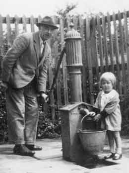 Getting water from a pump, early 1940s