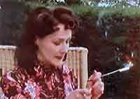 Woman smoking through a cigarette holder