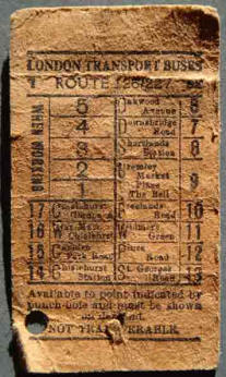 Back of a used 1940s London bus ticket, showing its price and a punch hole indicating the bus stop where the passenger must get off