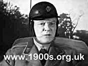 A man from the AA (Automobile Association) in the 1940s or 1950s
showing his uniform and helmet.