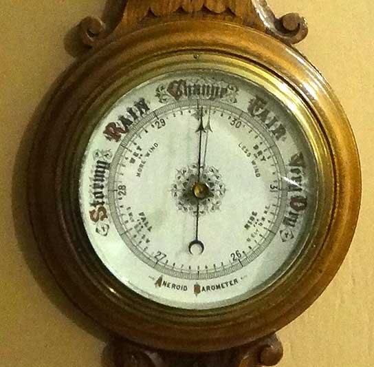 Wall mounted aneroid barometer in carved wooden case