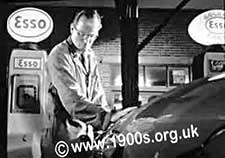 Garage attendant filling a car, as was the custom in 1940s-1960s Britain
