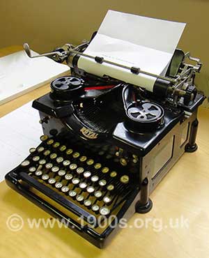 manaul typewriter side view showing the lever to move the paper to a new line