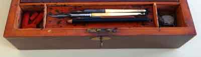Pen compartment of an Edwardian writing desk, with pens.