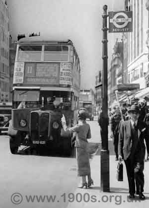 Hailing a London bus at a request stop in the late 1940s by holding out the left arm