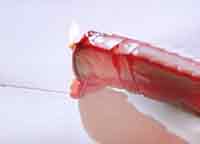 Hot, melted sealing wax being daubed into the sealed part of an envelope.