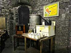 Room off the corridor of the WW2 public shelters under the battlements of Cardiff Castle showing facilities for basic cooking and water heating, small image