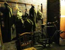 Room off the corridor of the WW2 public shelters under the battlements of Cardiff Castle showing a bicycle and clothes, small image