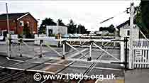 old-style manual level crossing closed to trains and open for road traffic, thumbnail