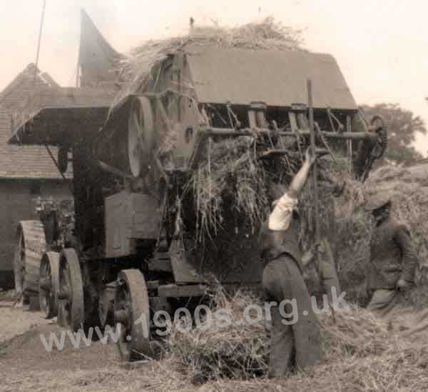 Straw being delivered by an old threshing machine