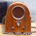 A 1940s radio with two knobs: one for on/off and volume and the other for tuning.