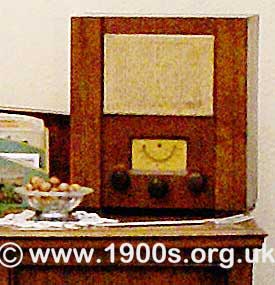 1940s radio, called a wireless. Note the three knobs for on/off, volume and tuning; the dial and the fabric covered speaker.
