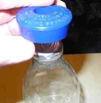How to use a plastic denter for opening a foil topped milk bottle