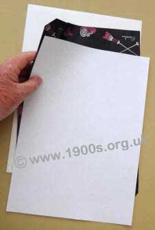 Carbon paper between two sheets of paper, ready for making a copy