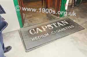 Rubber doormat outside shop advertising Capstan cigarettes, c1930s