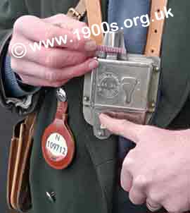 Mid 1900s bus conductor punching a bus ticket