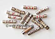 collection of 13 amp and 3 amp fuses