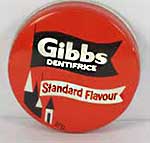Tin of Gibb's Dentifrice toothpaste - a solid pink 'cake' in either a red, green or blue tin