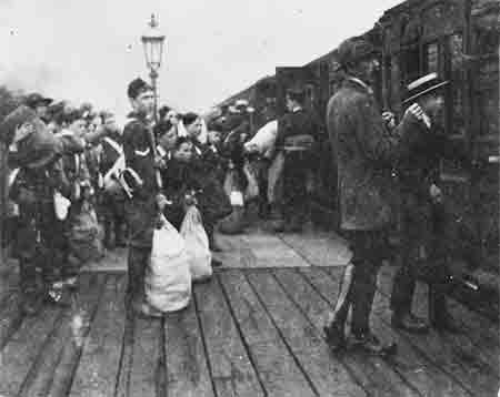 Silver Street Station, Edmonton, 1920, showing the platform of wooden planks and the gas lighting - from a photo of the 1st Edmontong Boys Life Brigade leaving for summer camp.