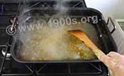 Stirring fat and water in roasting pan to clarify the fat and clean the pan