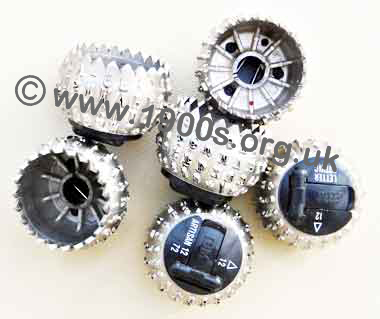 Selection golf ball print heads, showing the name of the font and the clip to fasten to the typewriter