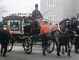 Coachman, seated high up at the front of a carriage