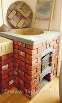 Reconstructed copper water heater showing where the
coal was fed in and where the ashes fell for removal.