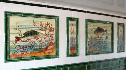 Tiled wall of an old fishmongers shop, showing pictures of fish in tiles