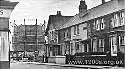 Working, gasometer expanded with coal gas from a gasworks, England, in the first part of the 20th century. Shows height compared with houses.