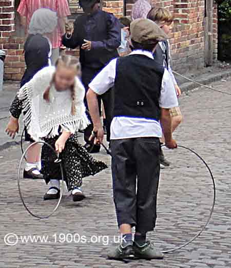 Children playing with old metal hoops