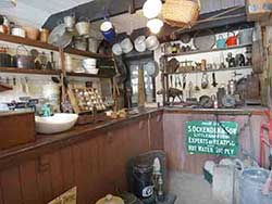 Inside an English ironmongers shop in the early 1900s, also known as a hardware shop or an oil shop