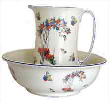 Old matching china flower-style jug and bowl for washing oneself where there was no access to a bathroom - common in the early 1900s, flower design on white