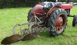 Vintage plough showing two sets of round cutting blade and larger turning blade