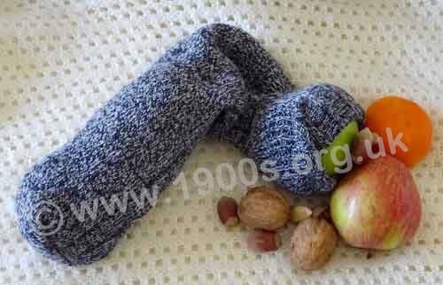 Christmas sock. typical early 20th century, partly tipped out showing the apple, orange and nuts.