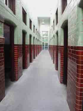 The main corridor of a casual ward, also known as a dosshouse, showing the doors of the cells.